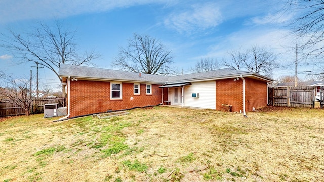 rear view of property with a lawn