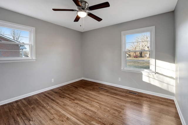 604 W 4th Ave, Hohenwald, TN 38462 - spare room with ceiling fan, hardwood / wood-style floors, and a wealth of natural light