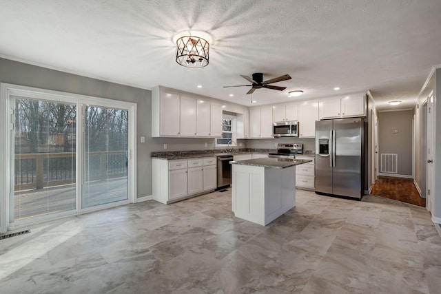 604 W 4th Ave, Hohenwald, TN 38462 - kitchen featuring white cabinetry, a center island, dark stone countertops, and appliances with stainless steel finishes