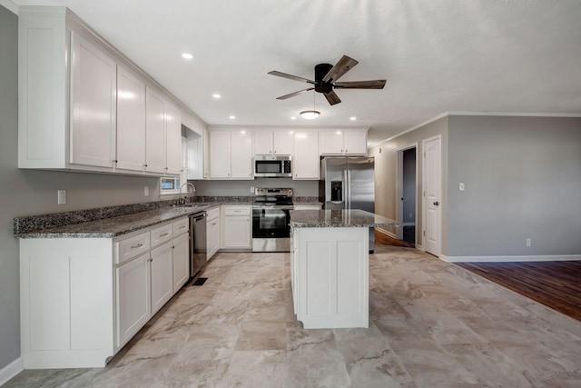 604 W 4th Ave, Hohenwald, TN 38462 - kitchen with white cabinetry, sink, dark stone countertops, a center island, and stainless steel appliances