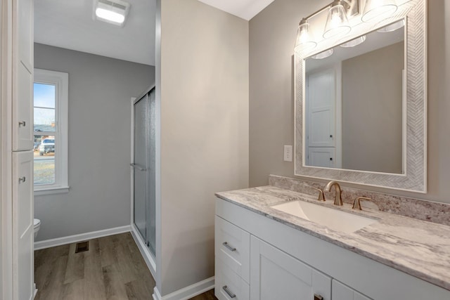 604 W 4th Ave, Hohenwald, TN 38462 - bathroom with vanity, toilet, a shower with shower door, and wood-type flooring