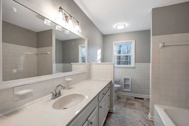 604 W 4th Ave, Hohenwald, TN 38462 - bathroom featuring tile walls, vanity, and toilet