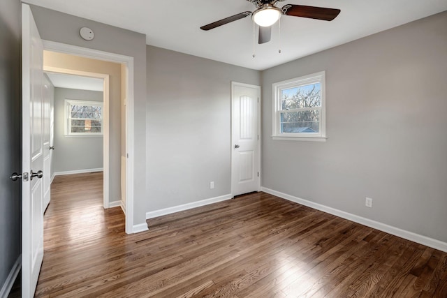 604 W 4th Ave, Hohenwald, TN 38462 - unfurnished bedroom with hardwood / wood-style flooring, ceiling fan, and multiple windows