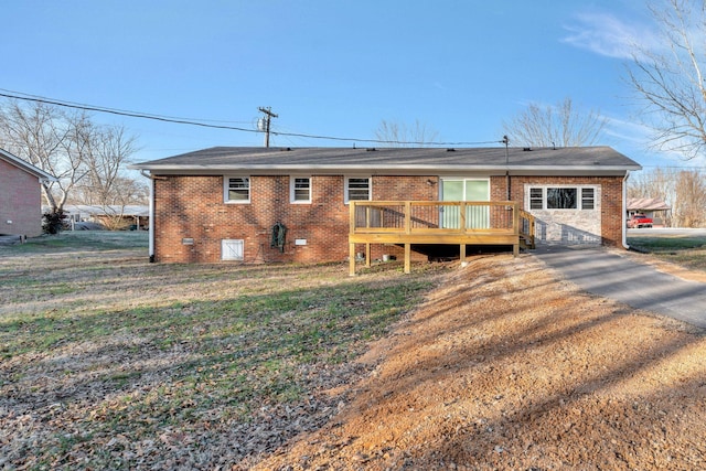 604 W 4th Ave, Hohenwald, TN 38462 - rear view of house with a garage, a yard, and a deck
