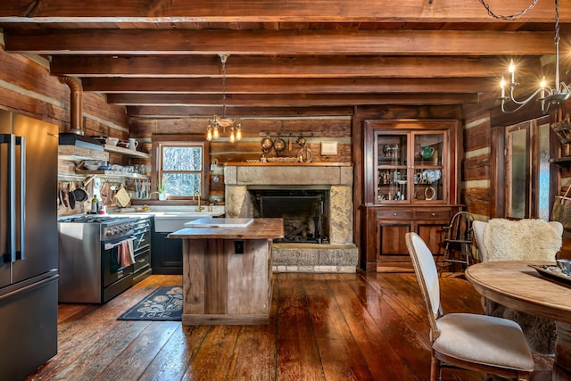 kitchen featuring hanging light fixtures, dark hardwood / wood-style floors, high quality appliances, and a kitchen island