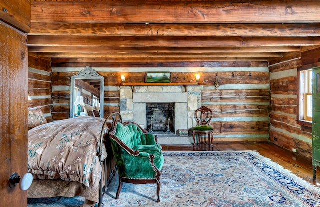 living room featuring a stone fireplace, wood walls, and hardwood / wood-style flooring