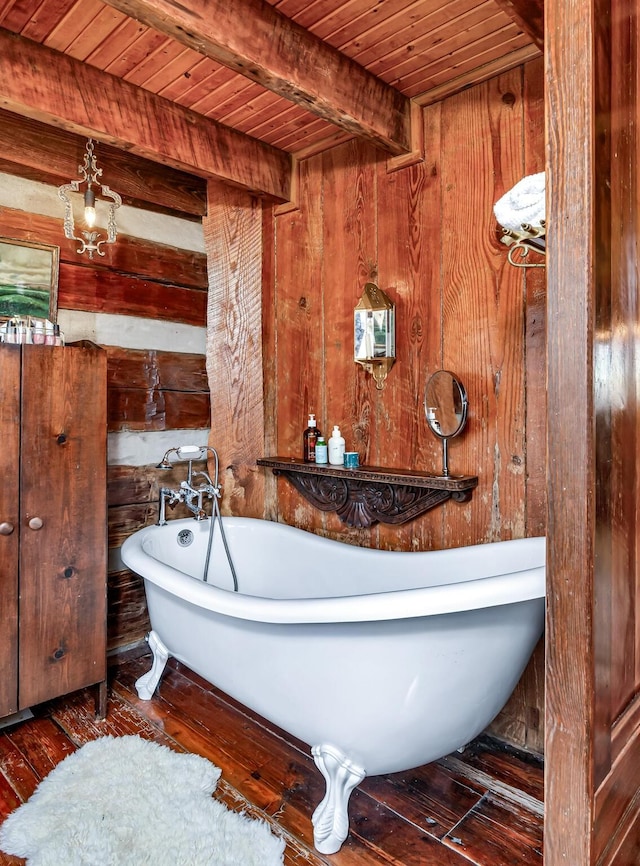 bathroom featuring a bathing tub, wood walls, beamed ceiling, wood-type flooring, and wood ceiling