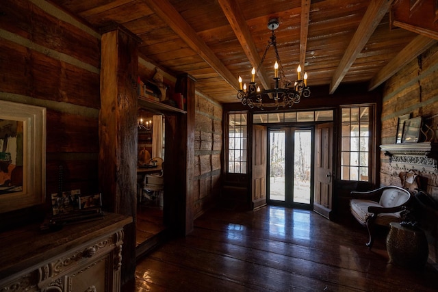 foyer entrance with french doors, wooden ceiling, dark hardwood / wood-style flooring, a notable chandelier, and beam ceiling