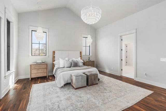 bedroom with lofted ceiling, dark hardwood / wood-style floors, and an inviting chandelier