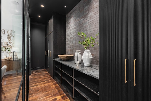 interior space featuring vanity, hardwood / wood-style flooring, and crown molding