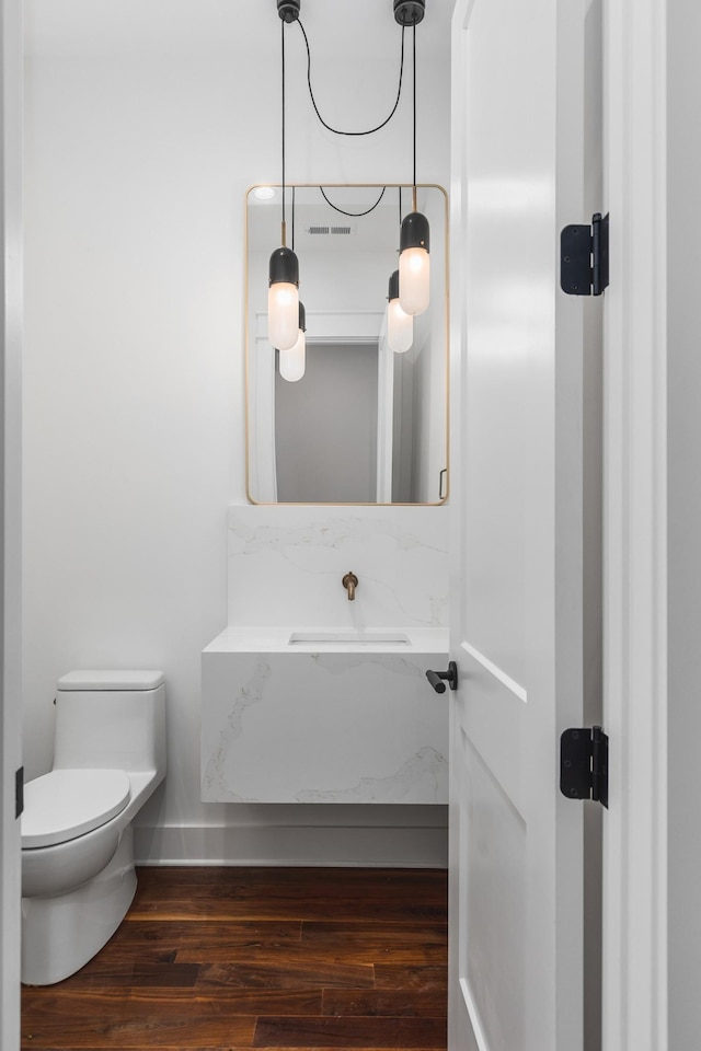 bathroom featuring toilet and hardwood / wood-style floors