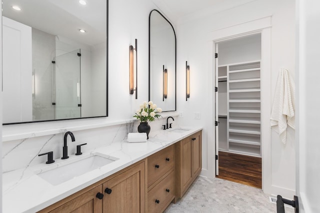 bathroom featuring vanity and an enclosed shower