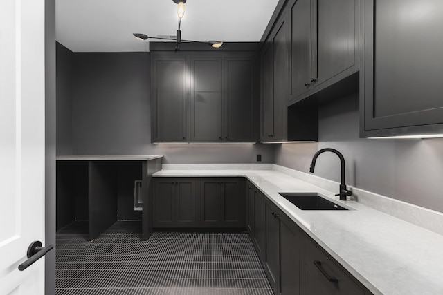 kitchen featuring sink and dark tile patterned flooring