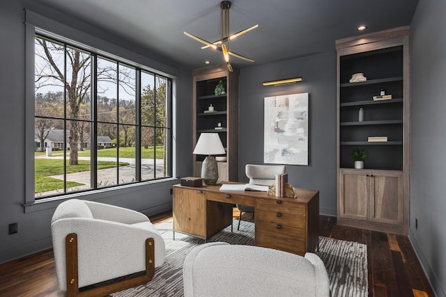 office featuring built in shelves and dark hardwood / wood-style floors