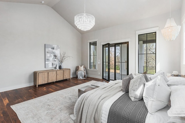 bedroom with lofted ceiling, multiple windows, access to exterior, dark hardwood / wood-style floors, and a notable chandelier