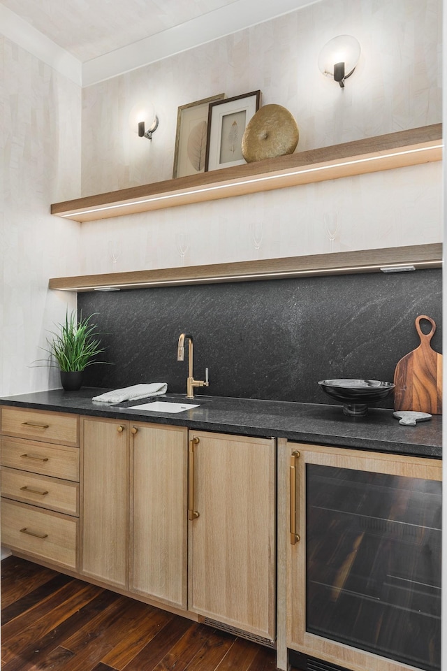 bar featuring sink, backsplash, dark hardwood / wood-style floors, light brown cabinetry, and beverage cooler