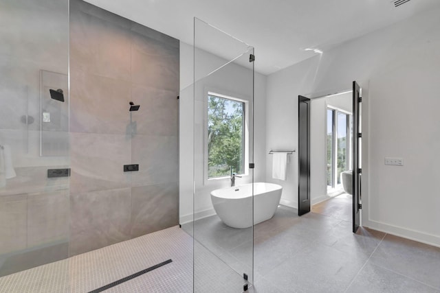 bathroom with tile patterned floors and plus walk in shower