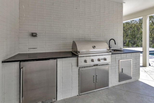 view of patio / terrace with sink, a grill, and exterior kitchen