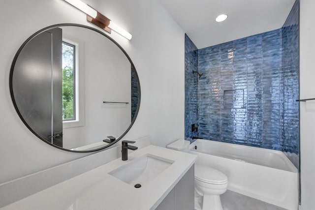 full bathroom featuring tiled shower / bath combo, vanity, and toilet