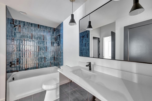 full bathroom with tile patterned flooring, tiled shower / bath, sink, and toilet