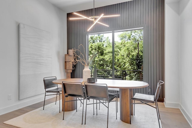 dining room featuring an inviting chandelier and light hardwood / wood-style flooring