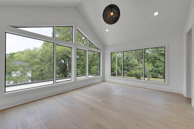 unfurnished sunroom featuring vaulted ceiling