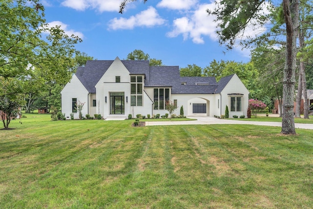 view of front of house featuring a garage and a front lawn