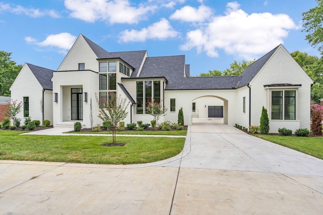 view of front of property with a garage and a front lawn