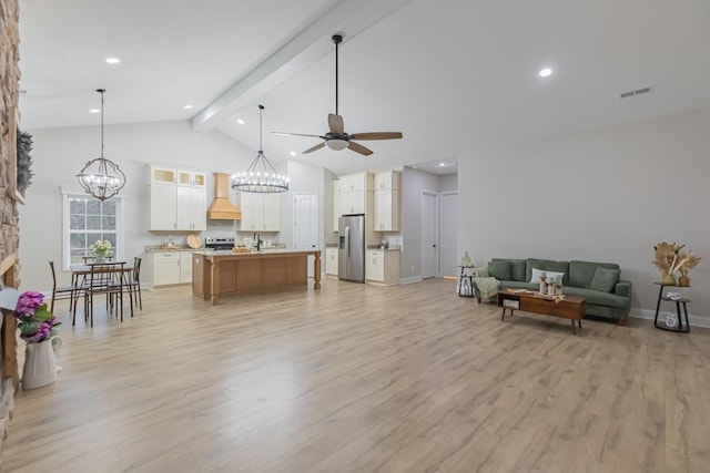 living room featuring ceiling fan with notable chandelier, high vaulted ceiling, sink, light hardwood / wood-style floors, and beam ceiling