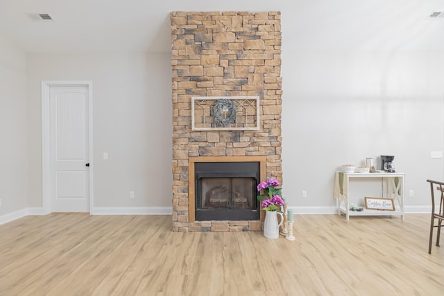 living room with a fireplace and light hardwood / wood-style flooring