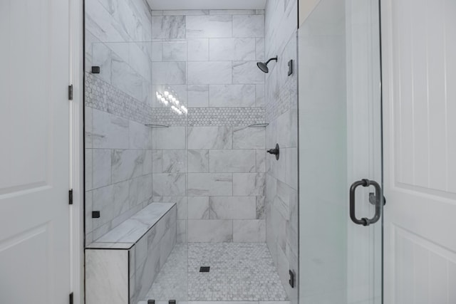 bathroom featuring a shower with door