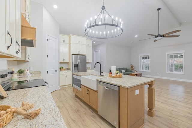 kitchen featuring sink, white cabinetry, hanging light fixtures, appliances with stainless steel finishes, and an island with sink