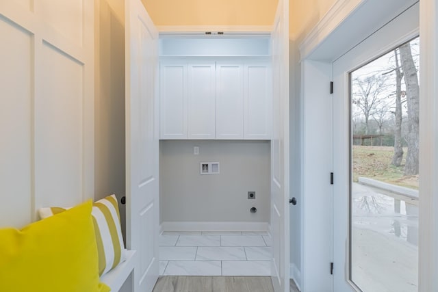 clothes washing area featuring electric dryer hookup, hookup for a washing machine, and cabinets