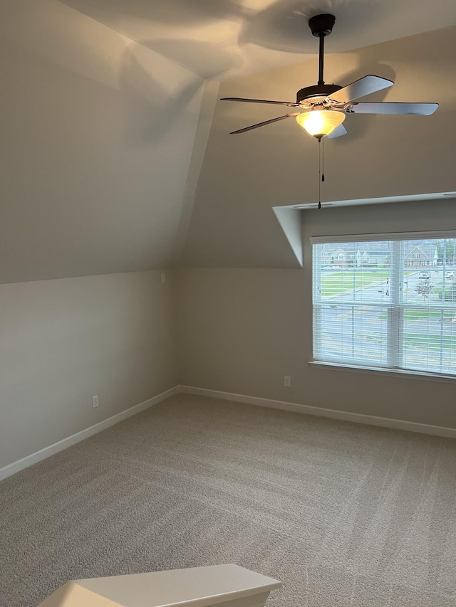 bonus room with vaulted ceiling, carpet, and ceiling fan