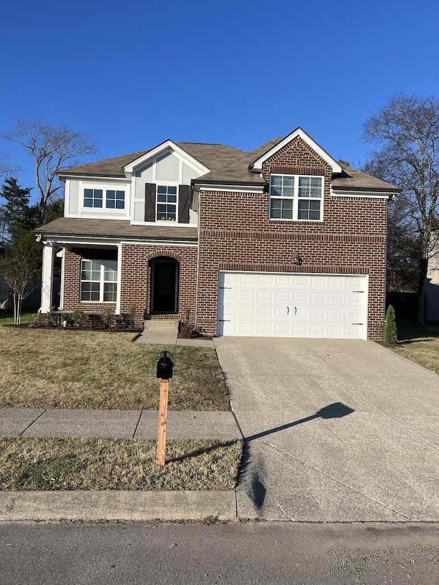 view of front of property featuring a garage and a front yard