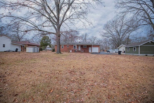 exterior space with a garage and a shed