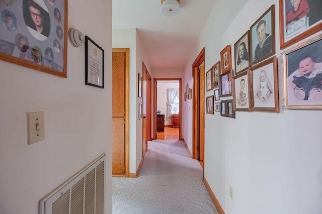 hall with light colored carpet