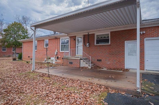 rear view of property with a garage