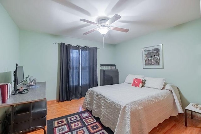 bedroom with hardwood / wood-style floors and ceiling fan