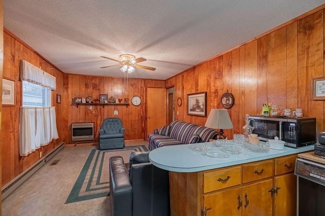 interior space featuring ceiling fan, light colored carpet, heating unit, and a textured ceiling