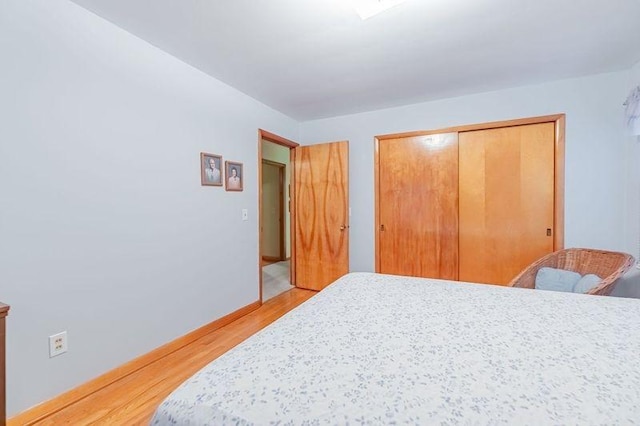 bedroom featuring light hardwood / wood-style floors and a closet