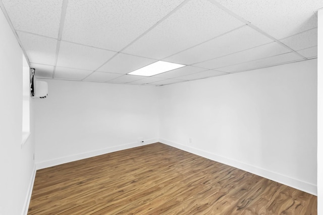 basement featuring hardwood / wood-style floors and a drop ceiling