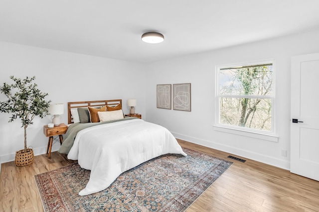 bedroom with hardwood / wood-style floors