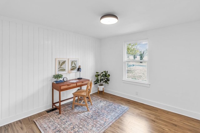 home office with hardwood / wood-style flooring