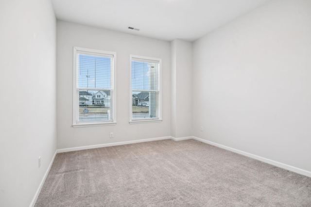 empty room featuring light carpet