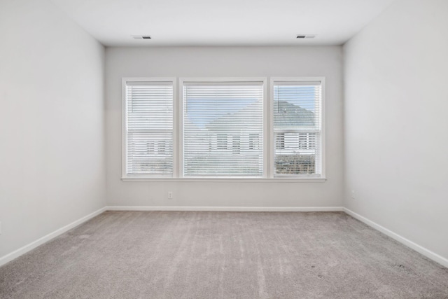 unfurnished room with light carpet