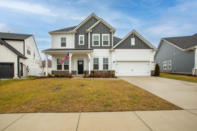 craftsman house featuring a garage, a front yard, and covered porch