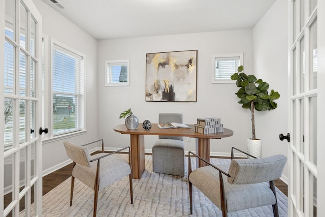 office with wood-type flooring and french doors