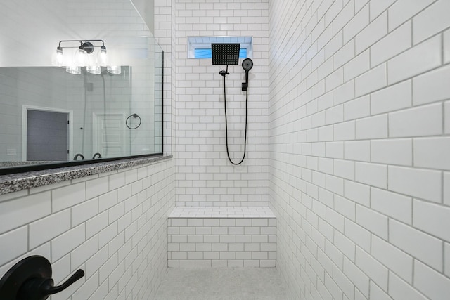 bathroom with tiled shower