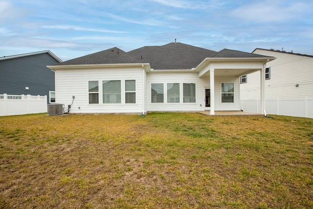 rear view of house featuring a yard, a patio area, and central air condition unit